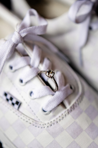 Alternative brides engagement ring resting on a pair of Vans trainers before her wedding in Norwich