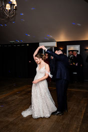 Couple spinning on the dance floor at Houchins wedding
