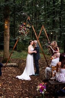 First kiss during the woodland wedding ceremony at Teybrook Orchard, the Browning Brothers Essex wedding venue