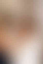 Bride laughing while having her make up applied at Houchins in Essex