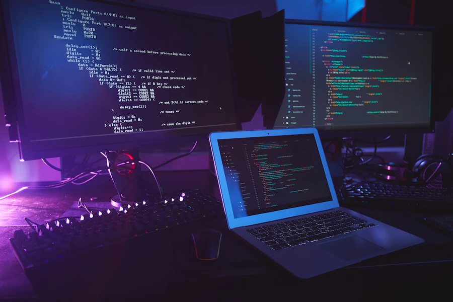 various-computer-equipment-with-programming-code-screens-table-dark-room-cyber-security-co