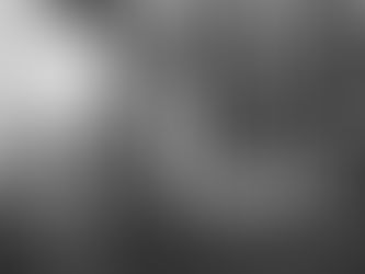 A young African-American man wearing protective gear stares at a wall of tubes and funnels