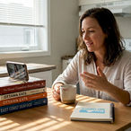 Small business owner filming video at kitchen table
