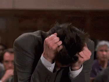 Lawyer burying head in hands in court — peak courtroom frustration during trial.