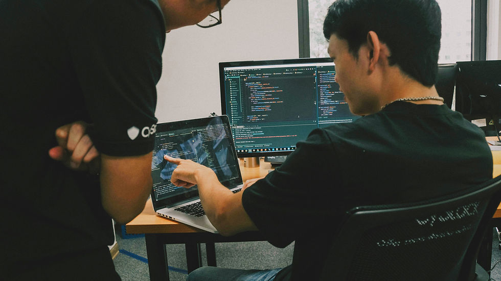 Two people looking at a computer screen