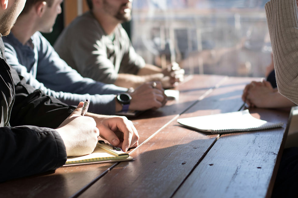 A group of people taking notes at a table