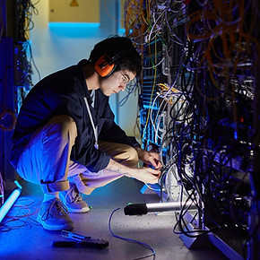 backend_developer_engineer_technician_works_with_servers_wires_cables_in_data_center_netwo