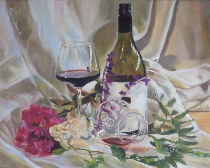 An original oil painting on stretched canvas. This is a still-life, depicting a wine bottle and 2 glasses, along with a conch shell and a bouquet of flowers. The style is soft and realistic, and much attention is given to the delicate glass. The background is a series of nearly abstract forms and shadows formed by draped white fabric. The palette is primarily purples, greens and magentas.