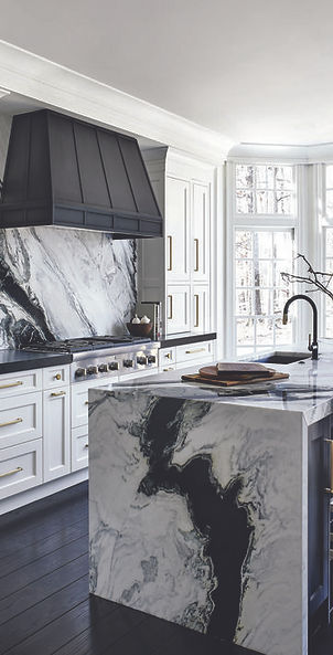Sleek kitchen island with a continuous stone countertop that cascades down the sides for a modern, seamless look.