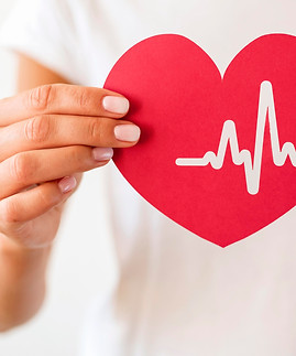 front-view-woman-holding-paper-heart-with-heartbeat.jpg