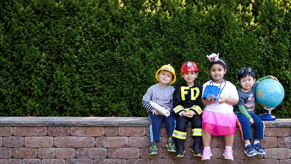 Kids in Dress-Up on a Garden Wall.png
