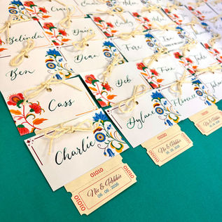 Handwritten name tags with raffle tickets on aqua background