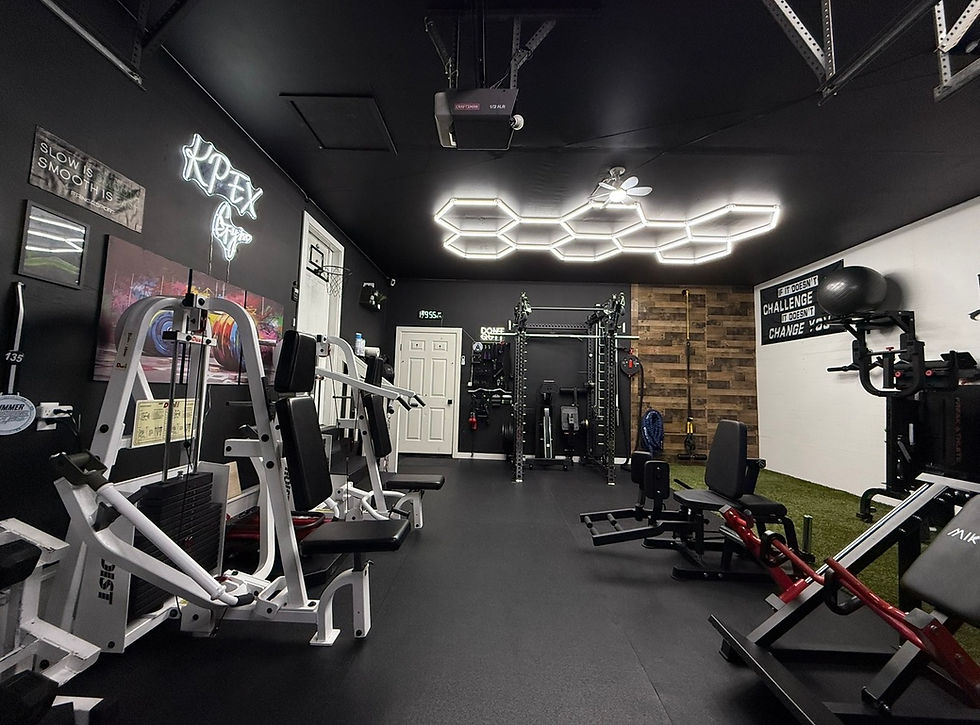 Modern home gym with black walls and hexagon ceiling lights