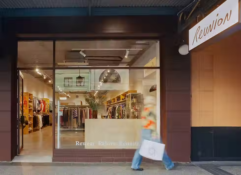 Reunion in Newtown shop face, with person walking in-front. A curated consignment store