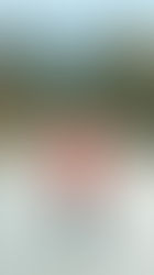 Woman standing on country road, with left turn option.