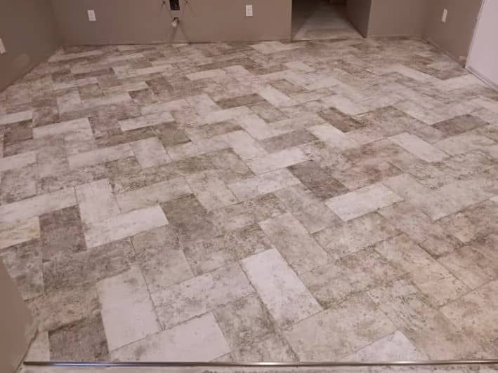 this porcelain tile looks worn down and feels like a cobble stone floor which adds to the old-world charm of this particular tile installation