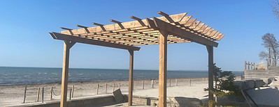 Wooden pergola structure on a waterfront deck – shade feature for outdoor living spaces