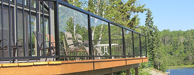 Refinished deck with black aluminum glass railings – example of deck replacement project