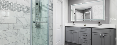 Remodeled bathroom with glass shower, tile walls, and gray vanity – bathroom renovation for modern home