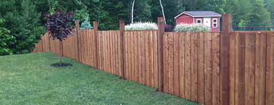 Tall privacy fence with pressure-treated wood panels – new fence installation project”