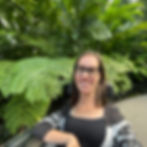 Disabled woman in a wheelchair taking a mental health break at a botanical garden. 