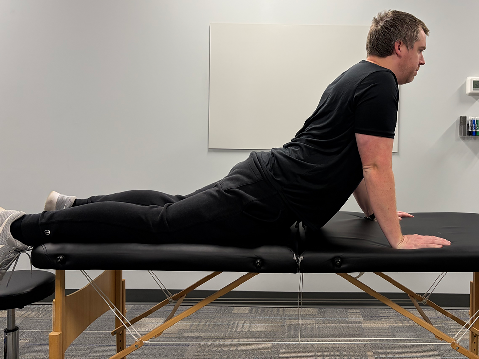 Dr. Danny Lehnert on a treatment table doing a prone press up