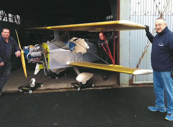 Aerosport Scamp is moved by Ulster Aviation Society volunteers, Adrian Evans, Jim Robinson and the late Steve Lowry
