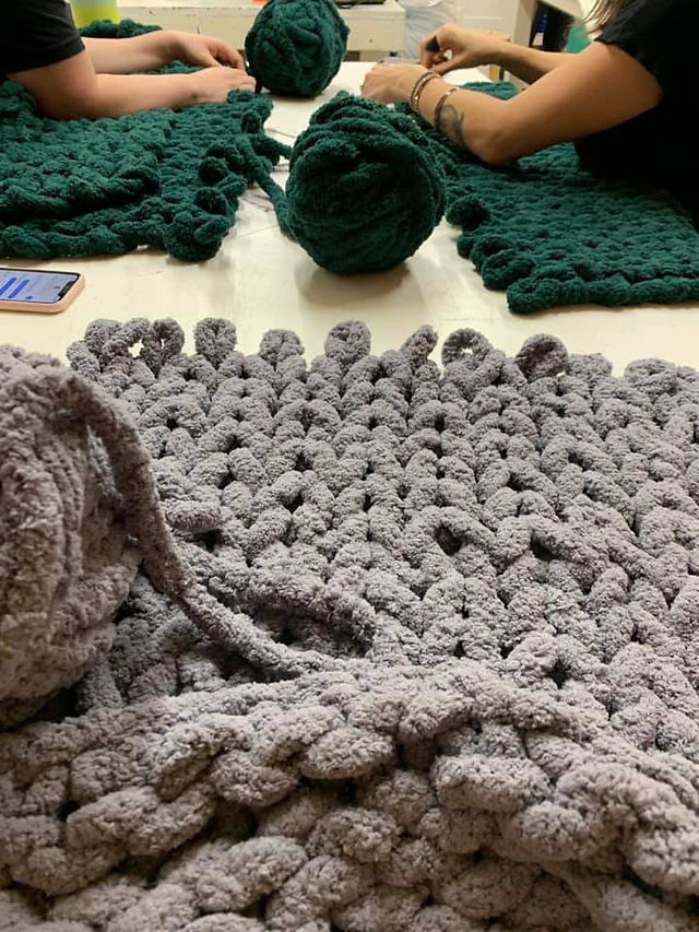 hand knitting chunky blankets at Studio 223 workshop in Gilbert.