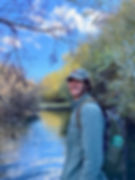 Cooper Lienhart smiles in front of a beaver dam