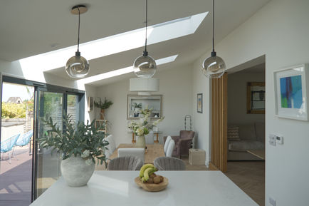 Modern kitchen with skylights and hanging lights. Freeman Architecture in Witney. Architectural and Interior Design Services.