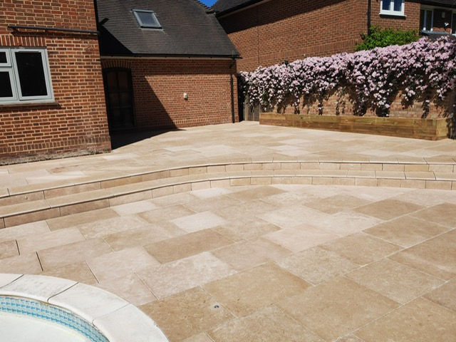 Beautiful textured stone with bullnosed steps and raised beds.