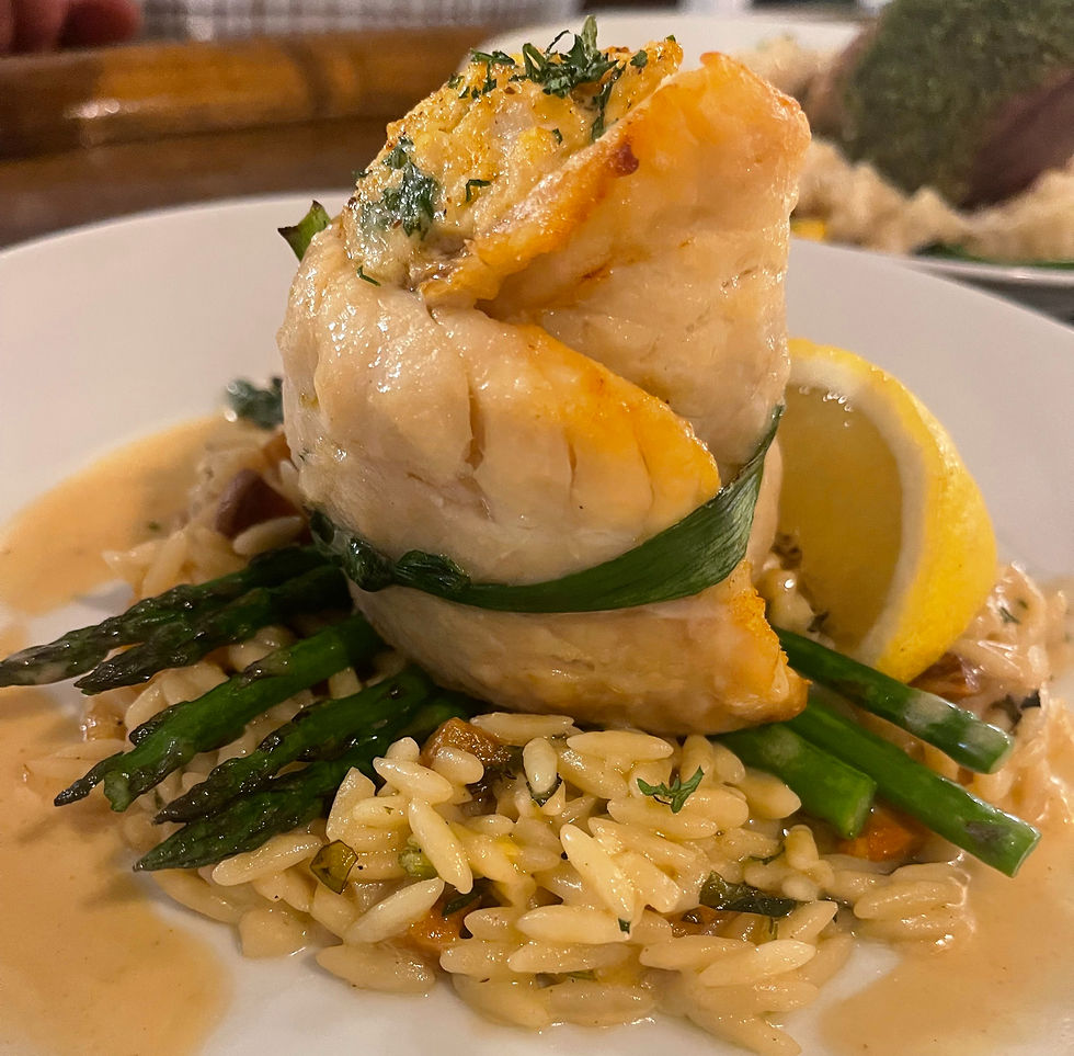 Leek-tied rockfish stuffed with crab over peach and basil orzo with asparagus and beurre blanc sauce as a special at Sugar Water Restaurant