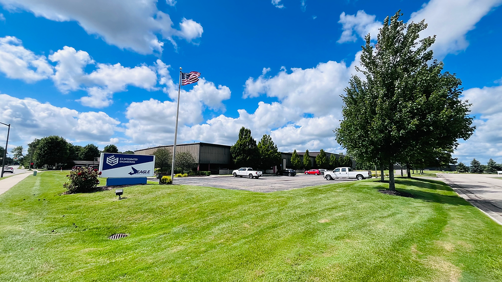 Hiller-Systems building in Zeeland, MI, with an American flag and well-maintained landscaping.