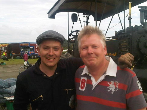 Matt and John from Beaming Restorations posing in front of a steam engine