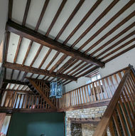 Large house with lots of wood beams before cleaning