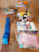 Educational materials and tools such as notebooks, crayons, and chalk, prepared for distribution