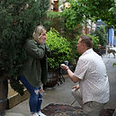 a man on his knee who is proposing to the love of his life as she looks on in shock, excitement and joy