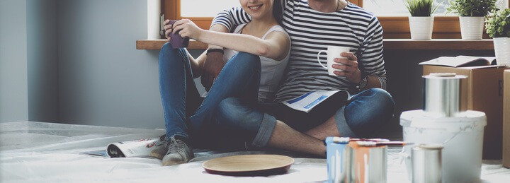 Couple Sitting Amidst Moving Boxes