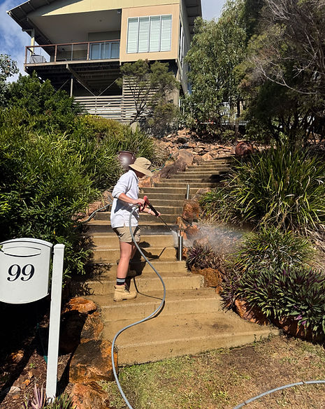 Caitlin is pressure cleaning concrete steps at a residential property on Castle Hill in Townsville