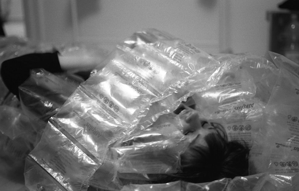 woman wrapped in transparent plastic, black and white