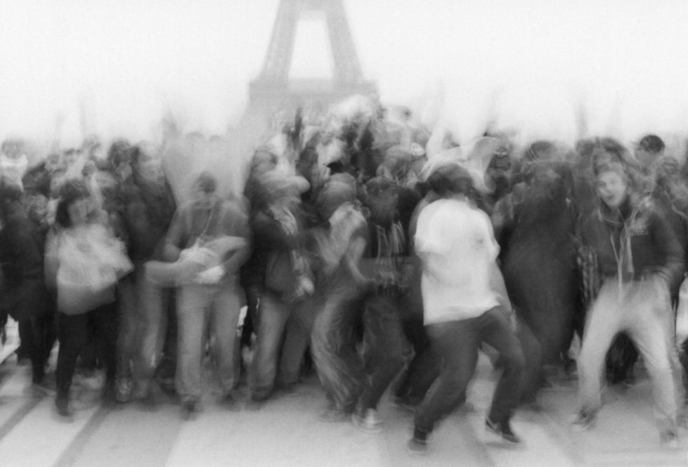 a group of young people doing a harlem shake in paris in front of the eiffel tower