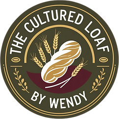 Artisan logo for The Cultured Loaf by Wendy showing a rustic sourdough loaf surrounded by wheat, with text in a circular badge design.