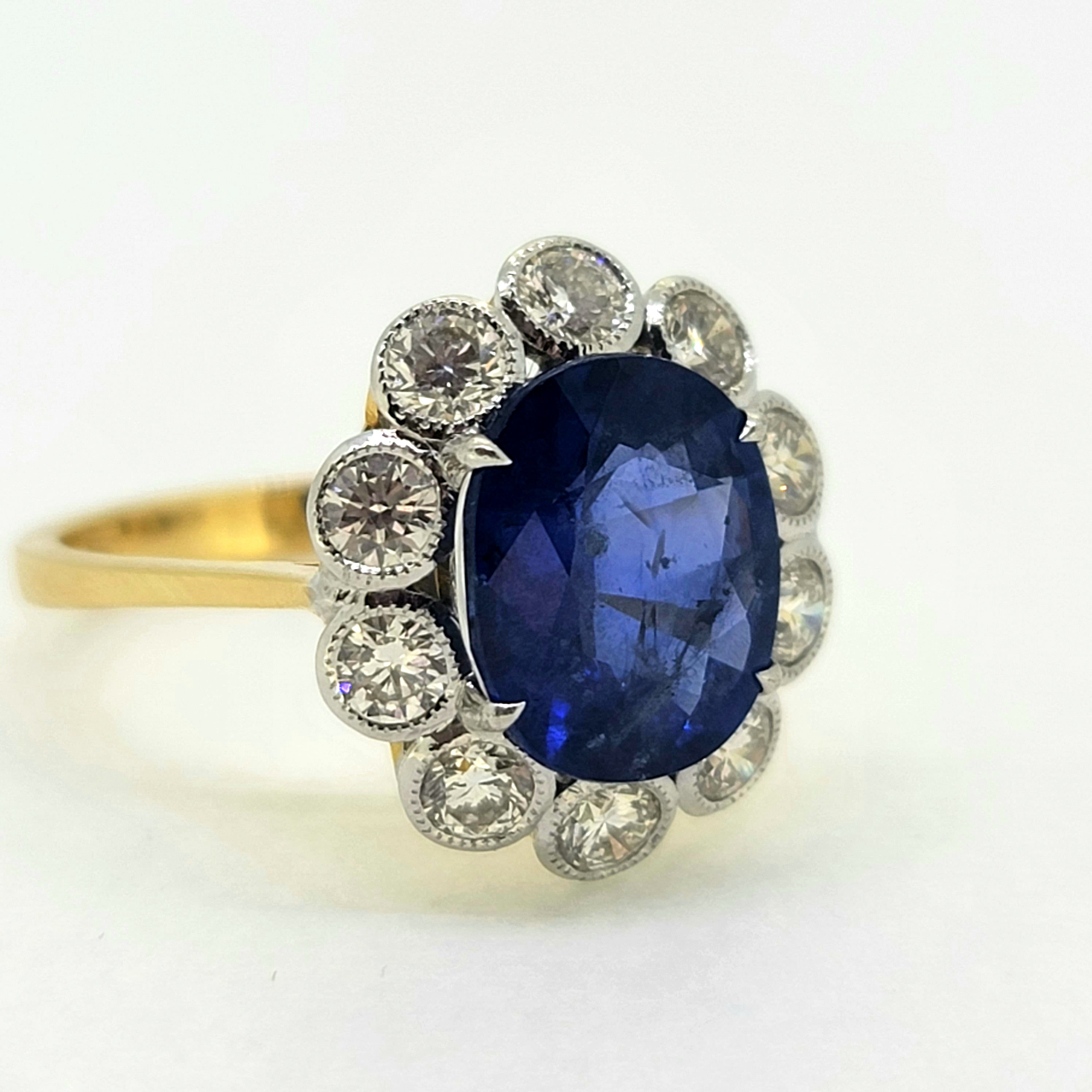 Oval sapphire and diamond cluster ring S4.62cts D1.21 cts