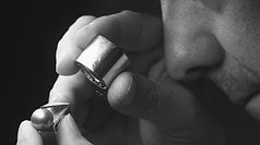 Man looking at diamond through eye piece