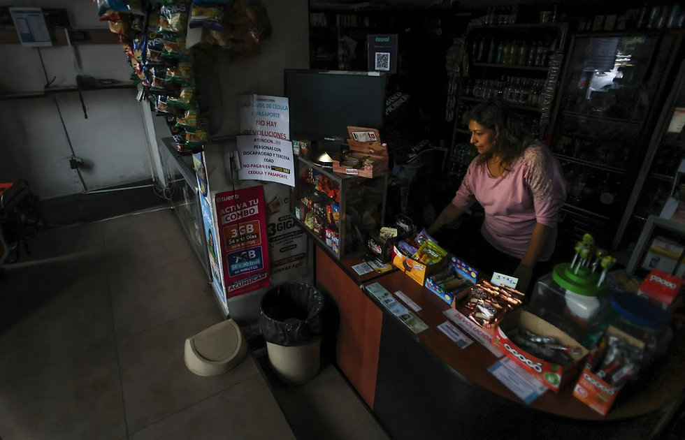 Store tender working the cashier without power. Many businesses are left without power, posing risks to economic health and people's well beings.