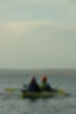 Couple enjoying a tandem kayak during an evening tour on Yellowstone Lake