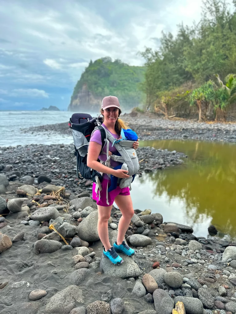 Adrianna hikes Polulu Valley with her son in a carrier on her chest, one of the best family hikes on the Big Island.