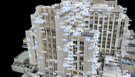 3D scan of a tall beige building covered with blue B-number labels on a black background