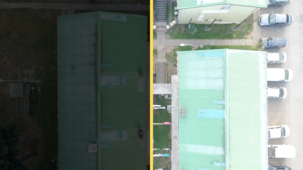 Split-screen aerial view of a green-roofed apartment building; one side dark, the other bright with parked cars and a sidewalk.