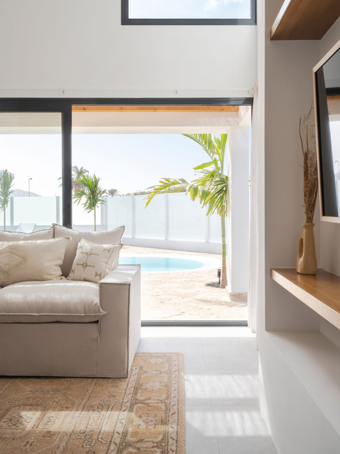 Living room with accesse to the terrace with pool. Villa Noma, luxury design holiday home villa with heated pool in Corralejo. Property Management by Luna Holiday Rentals Fuerteventura.